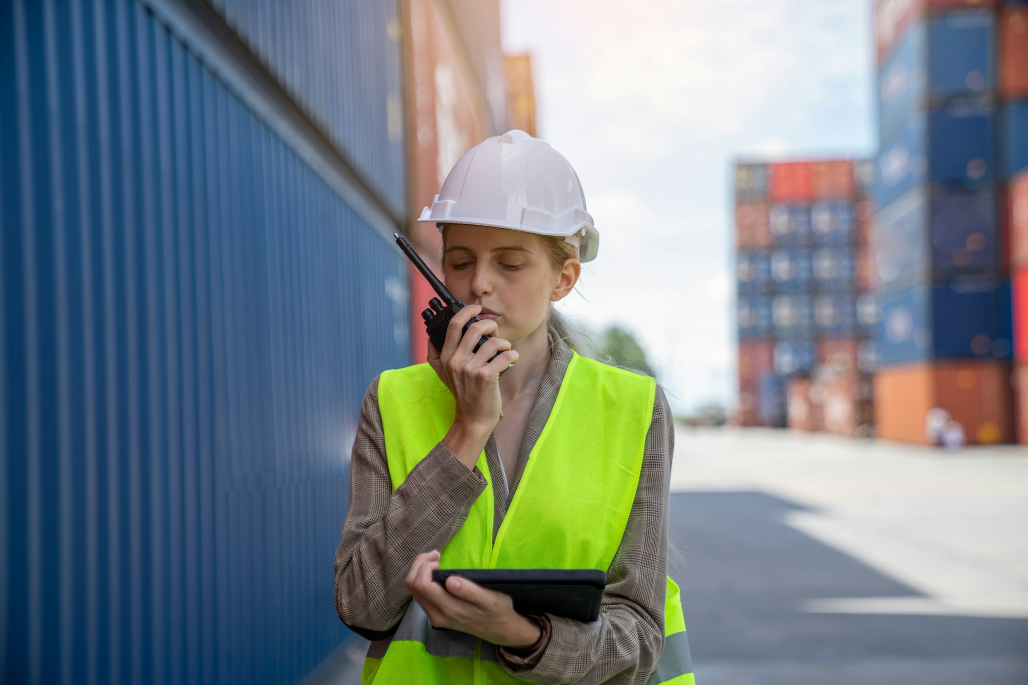 Female Manager technical using laptop to control the global freight through the network.