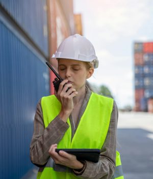 Female Manager technical using laptop to control the global freight through the network.